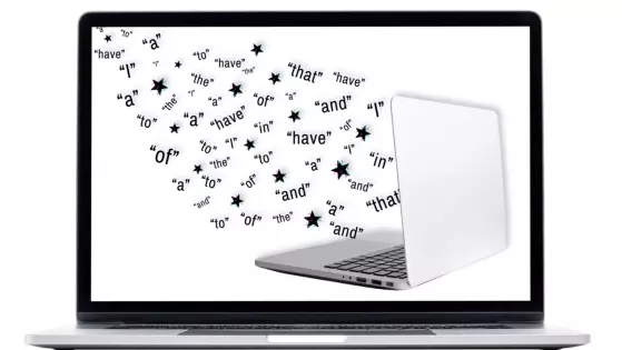 Image of words emerging from a laptop computer